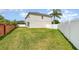 Spacious backyard with a well-maintained lawn and privacy fence at 289 Magnolia Park Trl, Sanford, FL 32773