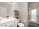 Bathroom featuring a vanity with vessel sink, toilet, and a tiled shower with patterned glass door to exterior at 289 Magnolia Park Trl, Sanford, FL 32773