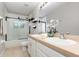 Bathroom features double sinks, granite countertops, modern light fixture, and shower with black frame at 289 Magnolia Park Trl, Sanford, FL 32773