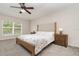 Bedroom with plush carpeting, a large window overlooking landscaping, and matching nightstands and lamps at 289 Magnolia Park Trl, Sanford, FL 32773