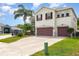 Charming two-story home featuring a two-car garage, landscaped yard, and a welcoming facade at 289 Magnolia Park Trl, Sanford, FL 32773