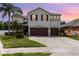 Charming two-story home featuring a two-car garage, landscaped yard, and a welcoming facade at 289 Magnolia Park Trl, Sanford, FL 32773