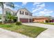 Charming two-story home featuring a two-car garage, landscaped yard, and a welcoming facade at 289 Magnolia Park Trl, Sanford, FL 32773