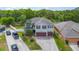 Aerial view of a two-story home with a well-maintained lawn and a three-car garage at 289 Magnolia Park Trl, Sanford, FL 32773