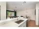 View of the kitchen featuring stainless steel sink and countertops and the adjoining game room and dining area at 289 Magnolia Park Trl, Sanford, FL 32773
