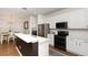 Bright kitchen with white cabinets, stainless steel appliances, and a spacious countertop bar, perfect for entertaining at 289 Magnolia Park Trl, Sanford, FL 32773