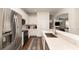 Bright kitchen featuring stainless steel appliances and eat-in counter, seamlessly flowing into the living area at 289 Magnolia Park Trl, Sanford, FL 32773