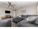 Comfortable living room featuring a large sectional sofa, TV, and ample seating space at 289 Magnolia Park Trl, Sanford, FL 32773