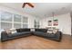 Spacious living room with hardwood floors, large windows, and a comfortable sectional sofa at 289 Magnolia Park Trl, Sanford, FL 32773