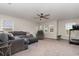 Spacious living room with a large sectional sofa, recliner chair, and natural lighting at 289 Magnolia Park Trl, Sanford, FL 32773