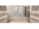Bright bathroom with dual vanities, walk-in shower and neutral tile floors at 3004 Cottage Grove Ct # 1805, Orlando, FL 32822