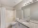 Bright bathroom featuring a granite countertop, white cabinets, shower and bathtub combination and great lighting at 3004 Cottage Grove Ct # 1805, Orlando, FL 32822