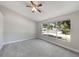 Bright, carpeted bedroom with ceiling fan and neighborhood view at 3004 Cottage Grove Ct # 1805, Orlando, FL 32822
