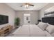 This staged bedroom has soft neutral colors, a full bed, and a view of the neighborhood through the window at 3004 Cottage Grove Ct # 1805, Orlando, FL 32822