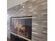 Close-up of fireplace featuring a decorative tile surround and a glass door, adding warmth and style to the living space at 3004 Cottage Grove Ct # 1805, Orlando, FL 32822