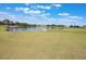 Manicured golf course with a sand trap, a pond and beautiful blue skies with puffy clouds at 3004 Cottage Grove Ct # 1805, Orlando, FL 32822