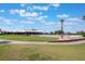Beautiful golf course view with the club house, pool and palm trees under a blue sky at 3004 Cottage Grove Ct # 1805, Orlando, FL 32822