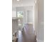 Upstairs hallway featuring wood floors, white banisters and trim, with a view of natural light from a nearby window at 3004 Cottage Grove Ct # 1805, Orlando, FL 32822