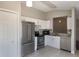 Contemporary kitchen featuring stainless steel appliances, white cabinets, granite countertops, and tiled floors at 3004 Cottage Grove Ct # 1805, Orlando, FL 32822