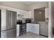 Modern kitchen featuring stainless steel appliances, white cabinets, granite countertops, and tile backsplash at 3004 Cottage Grove Ct # 1805, Orlando, FL 32822
