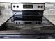 Modern electric stovetop with black surface and stainless steel controls at 3004 Cottage Grove Ct # 1805, Orlando, FL 32822