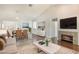 Open-concept living room with a fireplace, dining area, and hardwood floors at 3004 Cottage Grove Ct # 1805, Orlando, FL 32822
