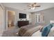 This primary bedroom features an ensuite bathroom, a TV, and a view of the neighborhood at 3004 Cottage Grove Ct # 1805, Orlando, FL 32822
