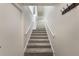 Clean, carpeted staircase featuring white railings, leading to the upper level, reflecting a bright and airy ambiance at 3004 Cottage Grove Ct # 1805, Orlando, FL 32822