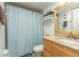 Bathroom with modern vanity, granite countertop, and a shower with a blue curtain at 3221 Westridge Blvd # 103, Orlando, FL 32822