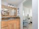 Bathroom with wooden vanity featuring granite countertop adjacent to bedroom at 3221 Westridge Blvd # 103, Orlando, FL 32822