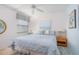 Bedroom features a plush blue comforter, coastal artwork, and two side tables with lamps at 3221 Westridge Blvd # 103, Orlando, FL 32822