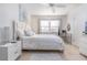 Bright bedroom showcasing neutral tile floor and white bedding with plush pillows at 3221 Westridge Blvd # 103, Orlando, FL 32822