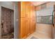 Welcoming entryway featuring a decorative door, storage cabinet, and neutral flooring at 3221 Westridge Blvd # 103, Orlando, FL 32822