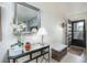 Entryway features decorative mirror, stylish console table and a view of the front door at 3221 Westridge Blvd # 103, Orlando, FL 32822