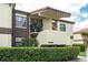 Inviting two-story condo featuring stucco exterior, decorative roof, and well-maintained front garden at 3221 Westridge Blvd # 103, Orlando, FL 32822