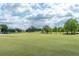 Beautiful golf course with lush green fairways and mature trees under a cloudy sky at 3221 Westridge Blvd # 103, Orlando, FL 32822