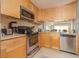 Functional kitchen with stainless steel appliances, ample wood cabinets, and countertops at 3221 Westridge Blvd # 103, Orlando, FL 32822