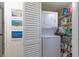 Laundry closet equipped with stacked washer and dryer, and shelving for ample storage at 3221 Westridge Blvd # 103, Orlando, FL 32822