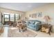 Bright living room featuring a comfortable sofa, accent furniture, and a sliding door to the patio at 3221 Westridge Blvd # 103, Orlando, FL 32822
