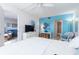 Bright main bedroom with a tranquil blue accent wall, offering a serene and stylish space at 3221 Westridge Blvd # 103, Orlando, FL 32822