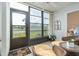 Relaxing sunroom with wicker furniture and large windows showcasing views of the surrounding landscape at 3221 Westridge Blvd # 103, Orlando, FL 32822