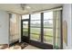 A sunroom with large windows and a ceiling fan is perfect for enjoying views of the outdoor green space at 3221 Westridge Blvd # 103, Orlando, FL 32822