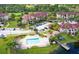 Aerial view of the community, showcasing the pool, pond, covered picnic area, and lush landscaping at 3702 Palm Desert Ln # 5435, Orlando, FL 32839