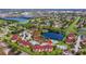 Aerial view of the community showcasing the building, pool and surrounding neighborhood and waterways at 3702 Palm Desert Ln # 5435, Orlando, FL 32839