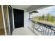 Balcony view of the parking lot, trees, and a black entry door to the condo at 3702 Palm Desert Ln # 5435, Orlando, FL 32839
