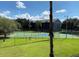 Community basketball court surrounded by lush greenery, providing a recreational space for residents at 3702 Palm Desert Ln # 5435, Orlando, FL 32839