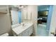 Updated bathroom vanity and view into kitchen at 3702 Palm Desert Ln # 5435, Orlando, FL 32839