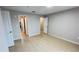 View of a bedroom with tile flooring and multiple entryways and doors at 3702 Palm Desert Ln # 5435, Orlando, FL 32839