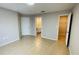 Bedroom featuring tile floors, multiple doorways, and access to a bathroom at 3702 Palm Desert Ln # 5435, Orlando, FL 32839