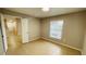 A charming bedroom featuring tile flooring and a bright, sunny window at 3702 Palm Desert Ln # 5435, Orlando, FL 32839